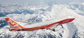 747-8 flying over snowy mountain range